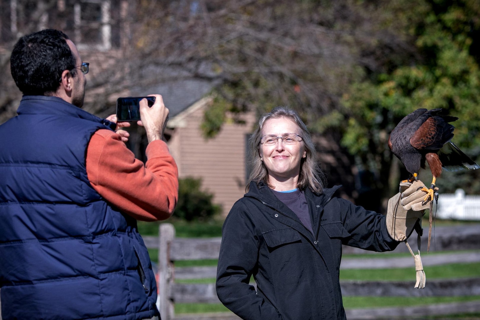 People outdoors with a bird of prey